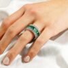Polished sterling silver eternity band with balanced stone arrangement