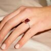 Ruby engagement ring with elegant side stones and hidden halo