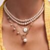 Pendant featuring pave-set CZ diamonds and pearl accents