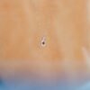 Blue sapphire pendant with CZ diamond halo and channel setting