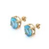 Dainty stud earrings with prong-set oval stones and diamond-inspired detail