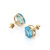 Oval stud earrings featuring blue topaz accents and a delicate finish