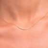 Curved bar necklace with round-cut CZ stones