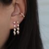 Sterling silver hoop earrings featuring thick gold plating and polished bezel settings
