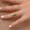 Necklace with baguette-cut emerald stones and diamond accents