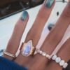 Oval-cut stone ring in pave setting with five accents