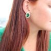 Playful sterling silver earrings with a bright green centre design