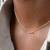 Mini bar necklace featuring nine CZ diamond accents in prong settings