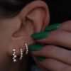 Delicate pearl mini hoop earrings measuring 12.5mm across