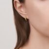 Gold-plated sterling silver hoop earrings with sculpted cat claw design