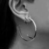 Large gold-plated hoop earrings with a fluid open-back curve